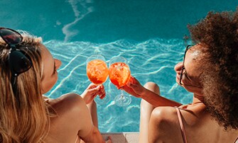 Oferta Relâmpago Bebidas Grátis em Varandas e Suítes, amigas conversando na piscina | MSC Cruzeiros
