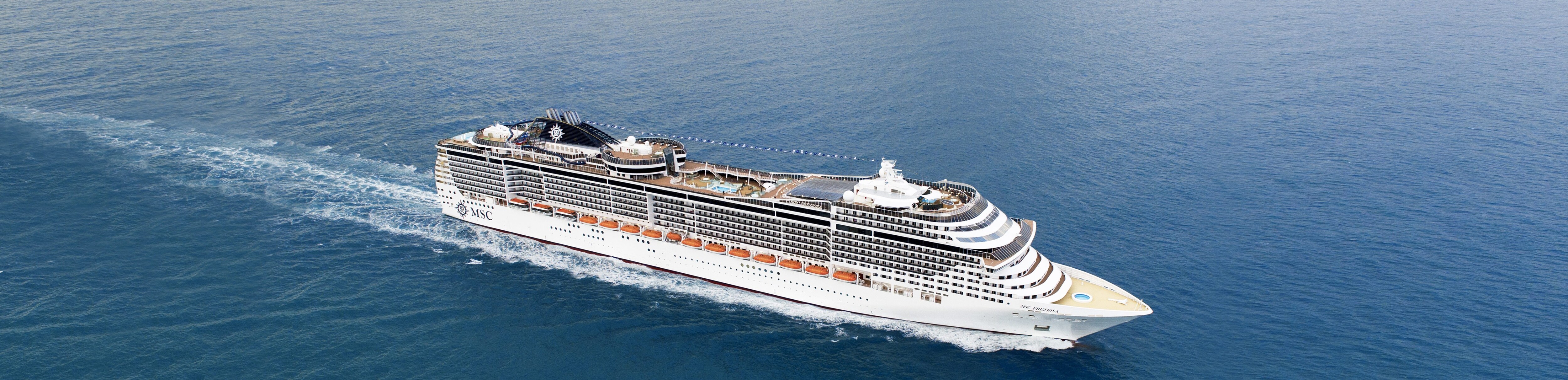 An MSC cruise ship gliding over calm blue waters | MSC Cruises