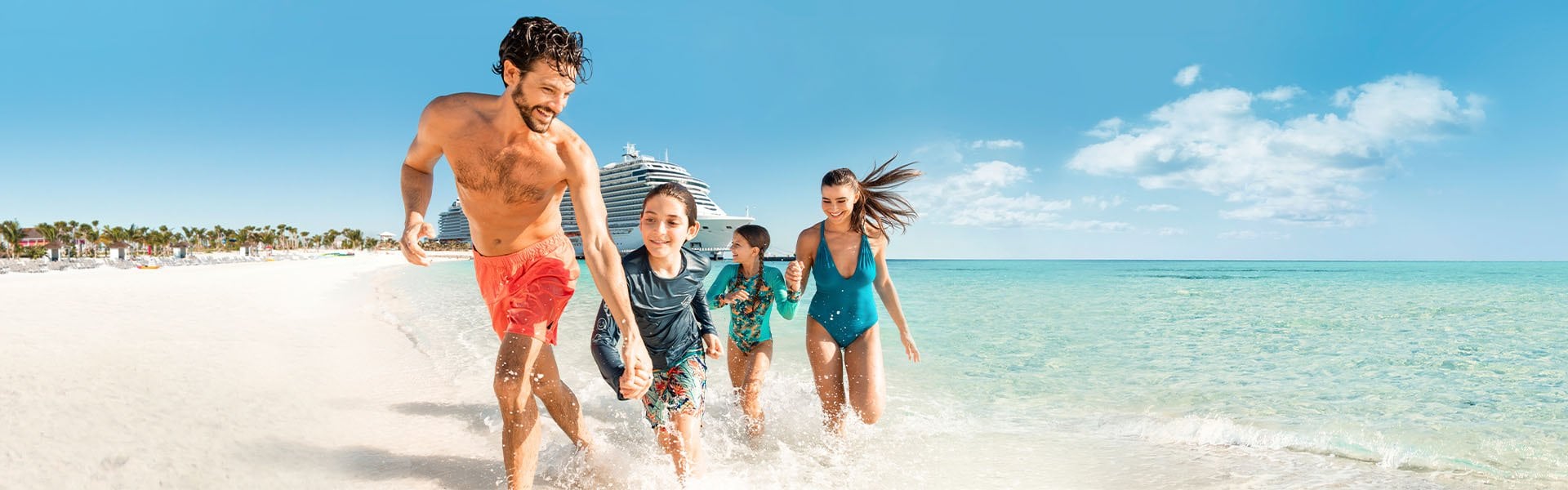 A family running on a tropical beach with a cruise ship in the background | MSC Cruises A family running on a tropical beach with a cruise ship in the background | MSC Cruises